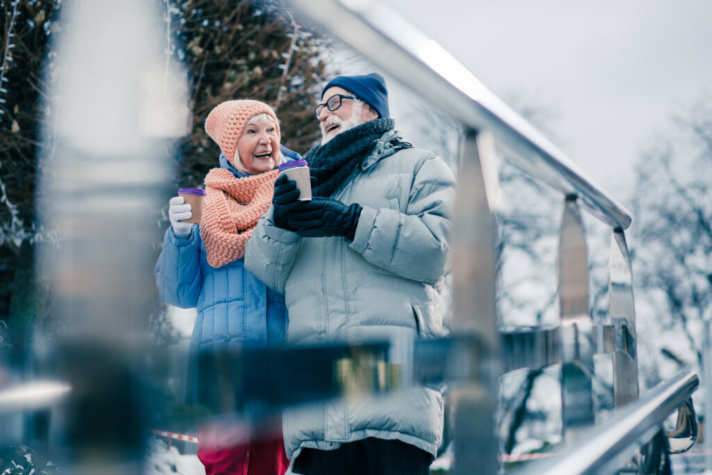 cheerful older couple walking outside in the winter