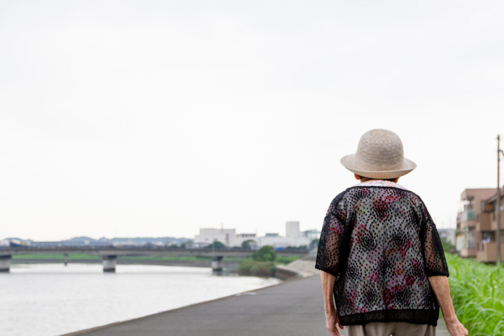 woman walks by a river
