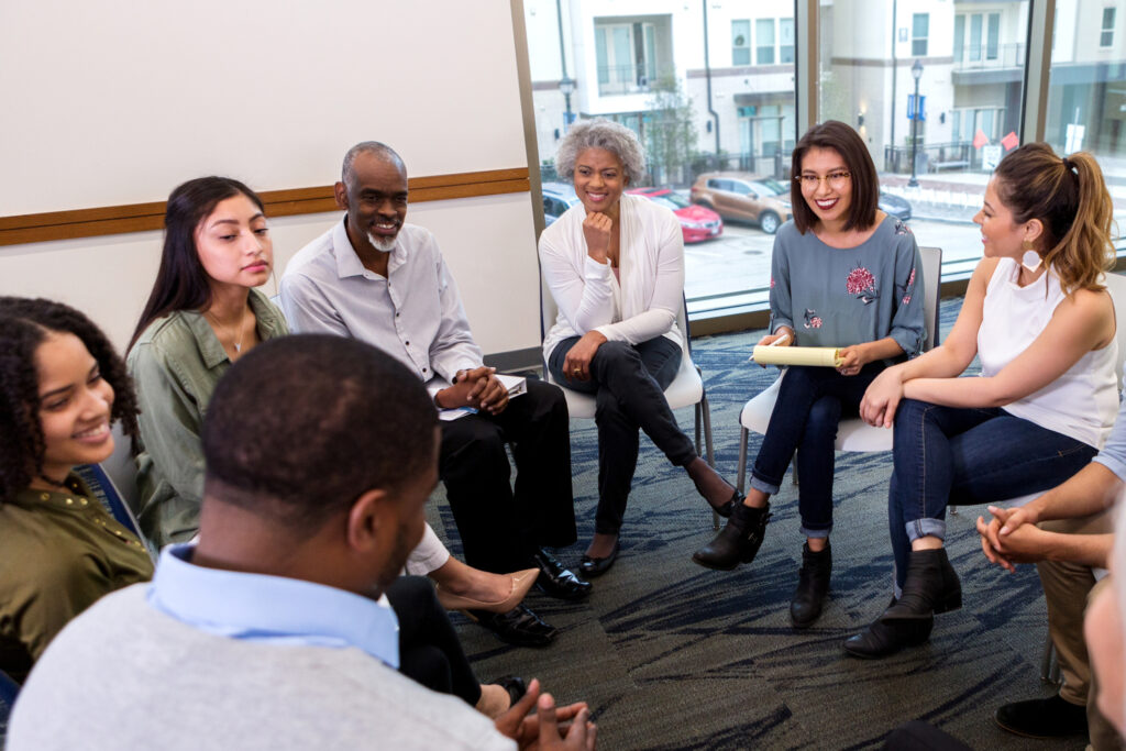 diverse group of people sitting in a circle having a conversation