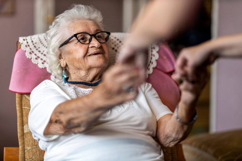 woman receiving assistance to stand up