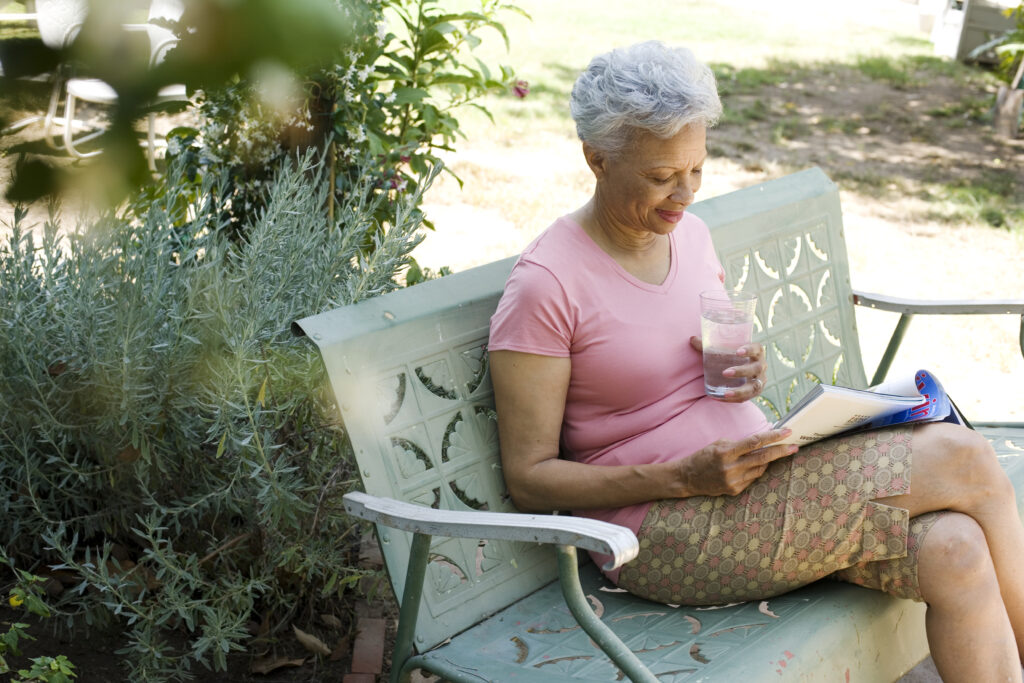 woman reading while sitting on a bench