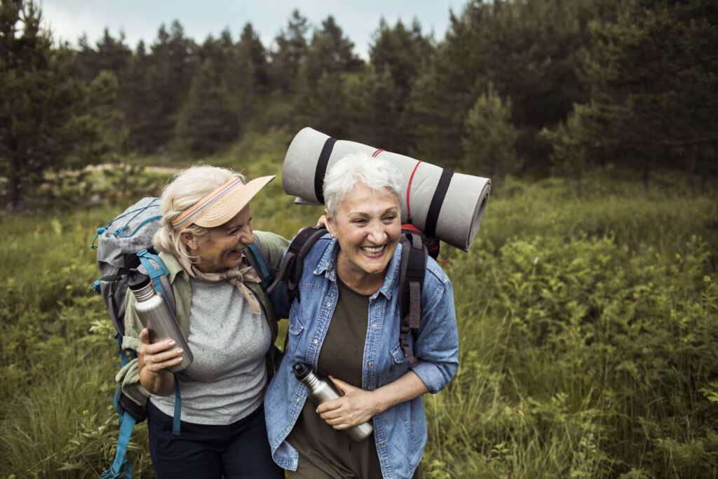 Close up of two senior female friends hiking together